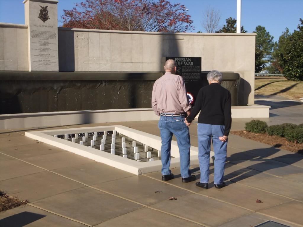A couple reflects at Huntsvilles memorial for Veterans.