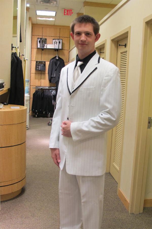 Devon Whitfield, a senior, getting the final fit for his tux.