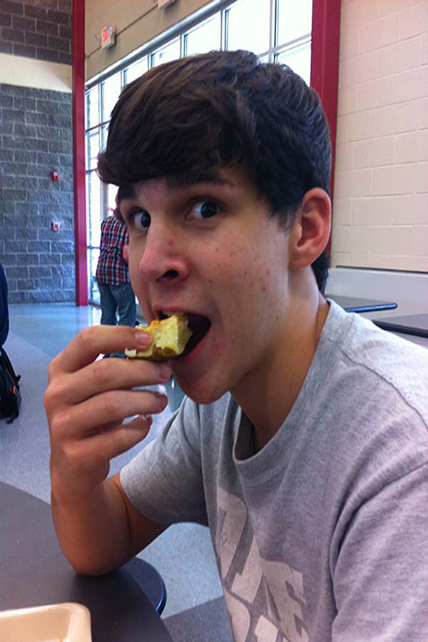 Dustin Guidry eating a potato with his new friends at lunch