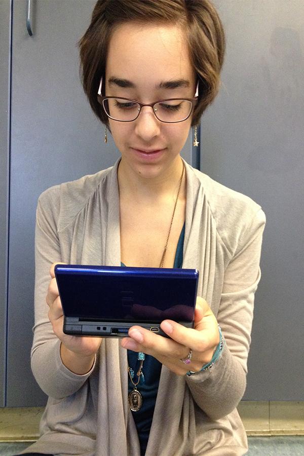 Kristie Martins playing a Nintendo DS Lite