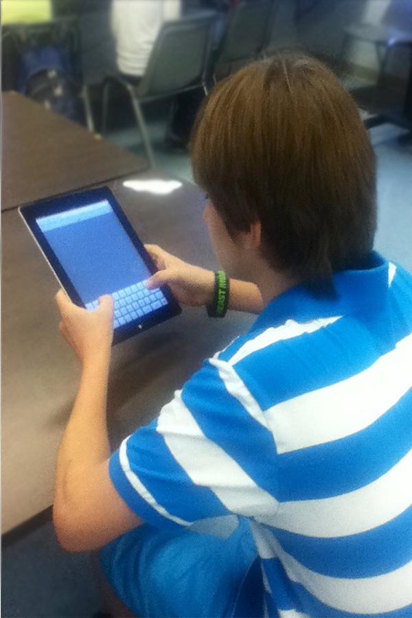 A multimedia design student uses an iPad to make a quick search.