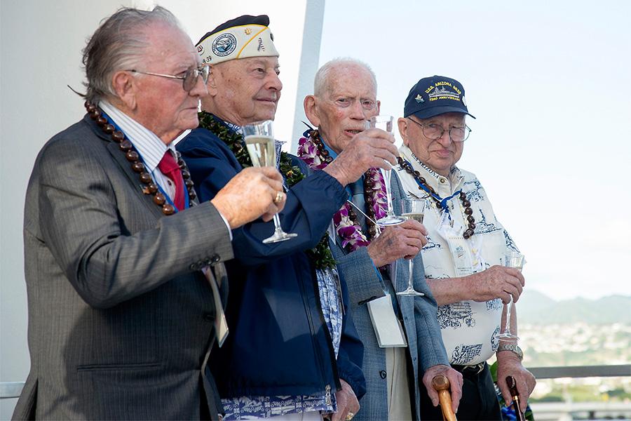 Three Pealr Harbor survivors toast to their fallen friends.
