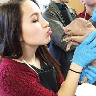 Emeline Earman poses with her fetal pig