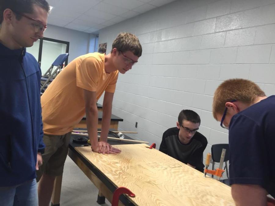 Team members, Eric, Riley, AJ, and William work on constructing the robot