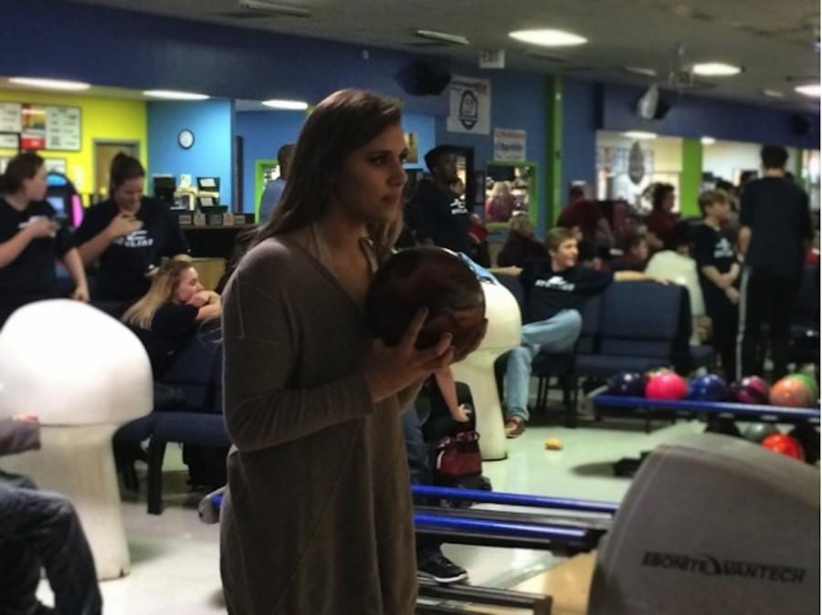 Paige Sander (grade 11) prepares for her turn to bowl during a Thursday practice.