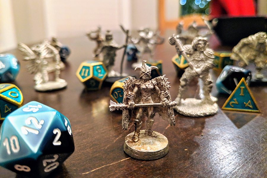 Mini figures and dice used in tabletop RPGs, specifically Dungeons and Dragons. 