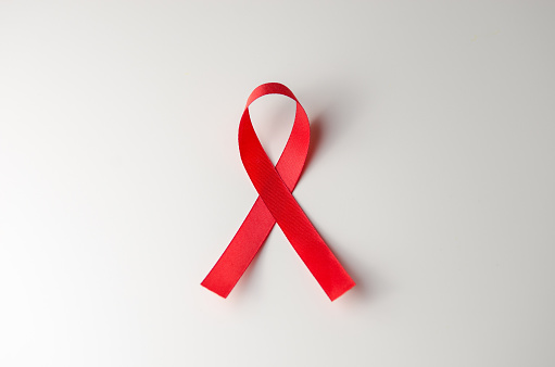 Red ribbon HIV, AIDS on gray background, Awareness, Medical sign. copy space.